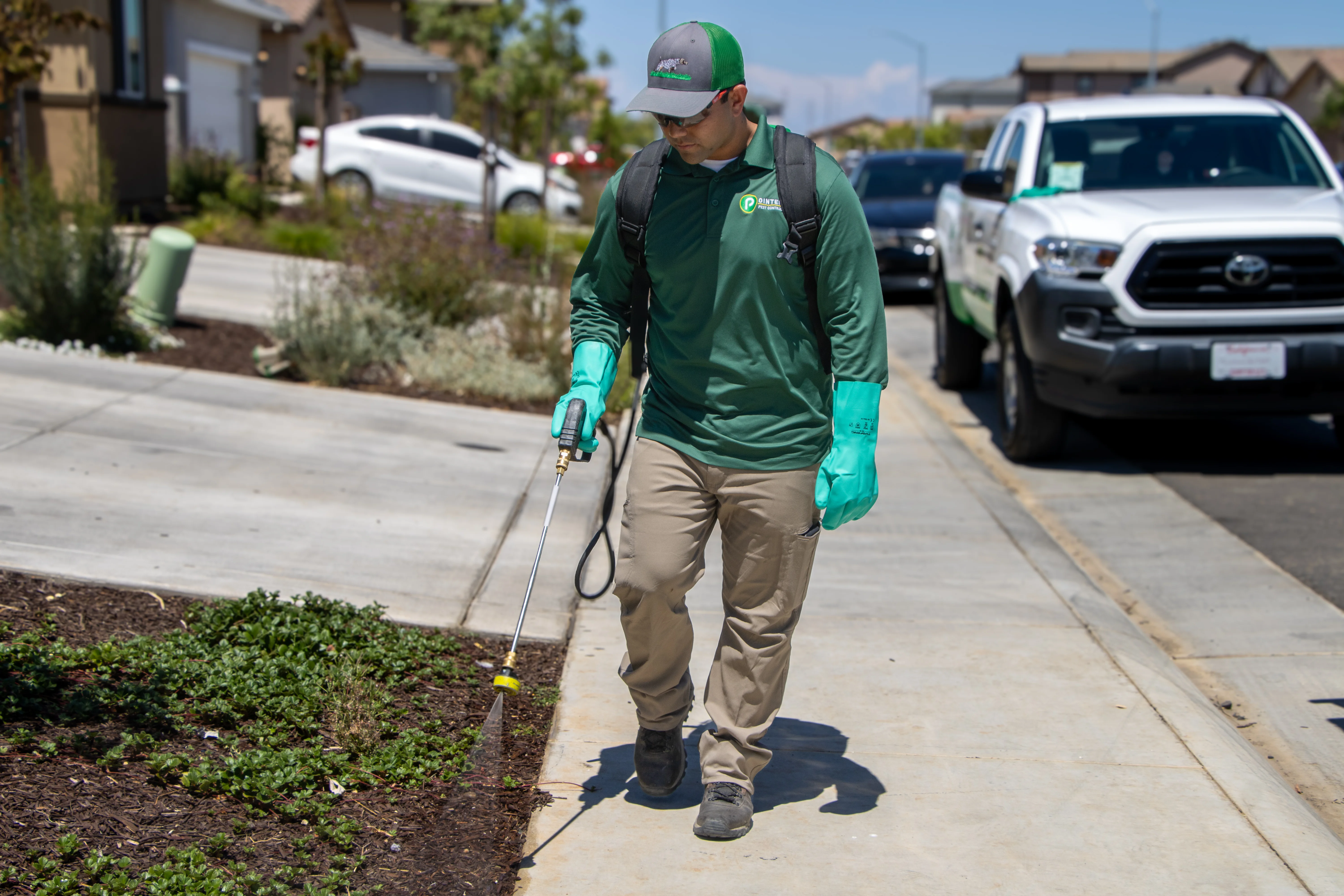 Pointer Pest Control technician treating a home exterior