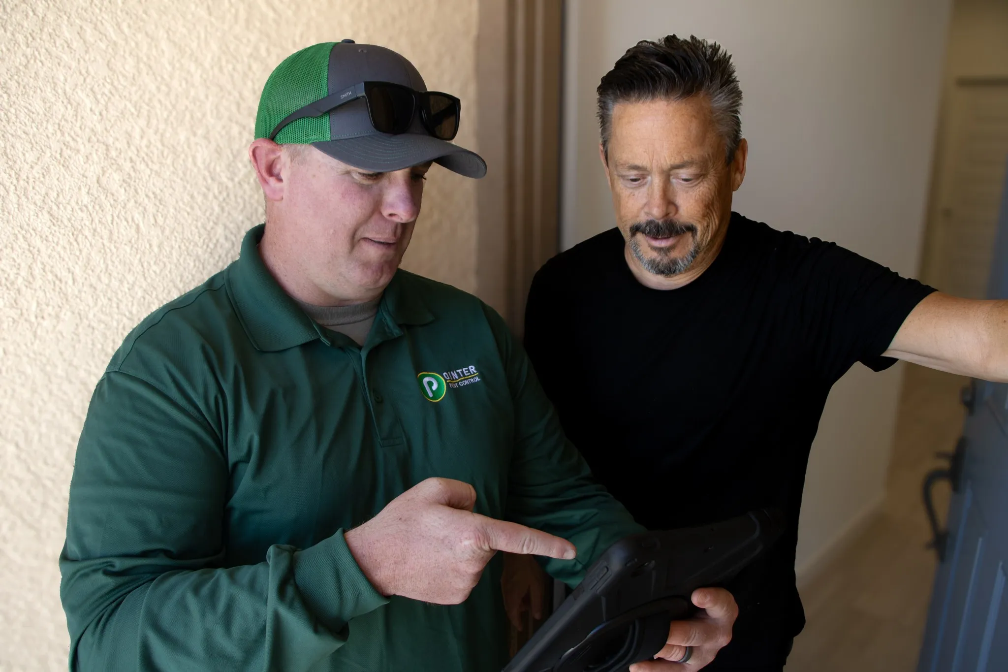 Pointer Pest Control technician walking a Roseville CA homeowner through their pest control quote on a tablet