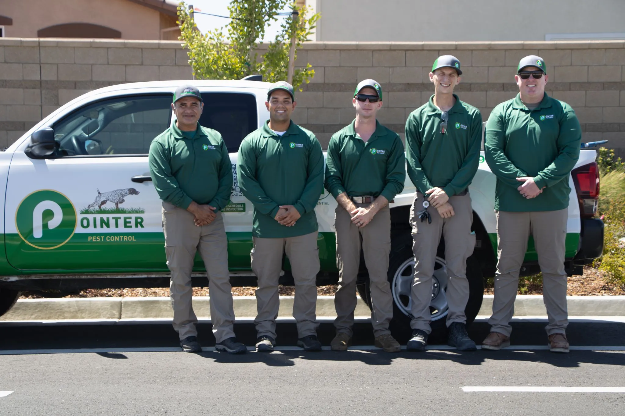 Pointer Pest Control technicians standing in front of a branded service truck in Roseville CA